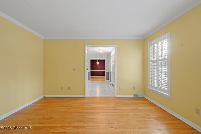 spare room with crown molding and light hardwood / wood-style flooring