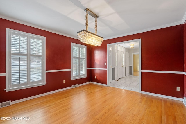 unfurnished dining area featuring a notable chandelier, a wealth of natural light, and hardwood / wood-style floors