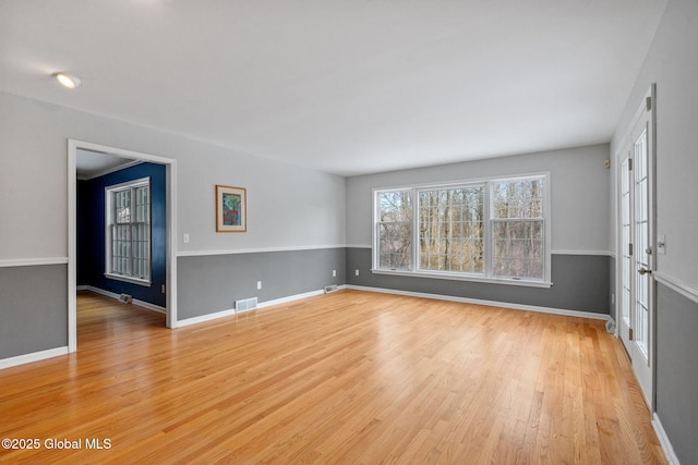 unfurnished room with light wood-type flooring