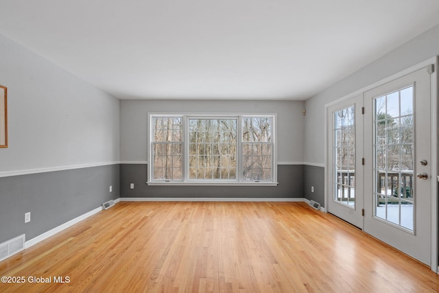 unfurnished room with light wood-type flooring