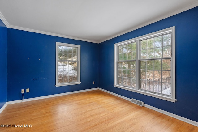 spare room with crown molding and hardwood / wood-style flooring