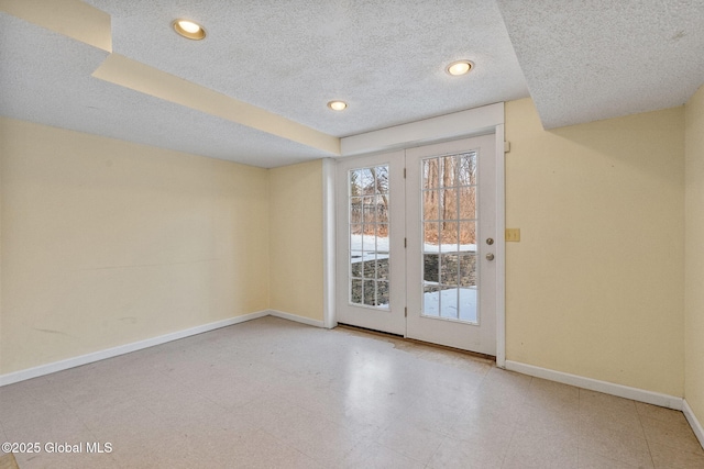 doorway to outside featuring a textured ceiling