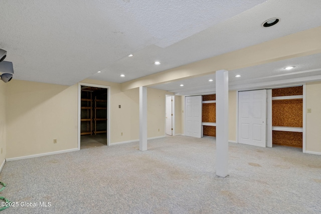 basement with light colored carpet and a textured ceiling