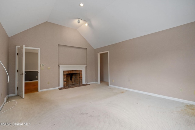 unfurnished living room with carpet floors, lofted ceiling, and a fireplace