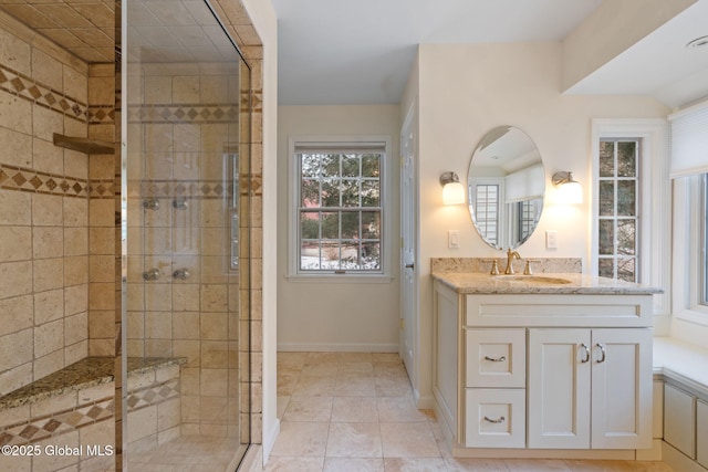 bathroom featuring an enclosed shower, vanity, and tile patterned flooring