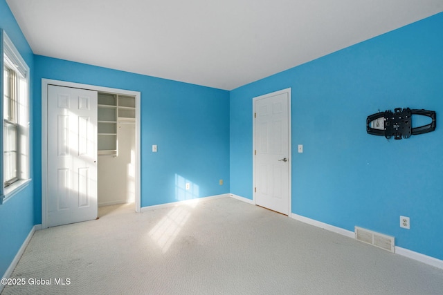 unfurnished bedroom with carpet floors and a closet