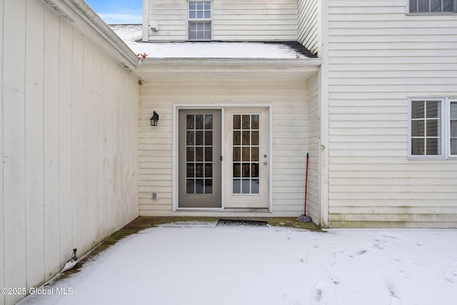 view of snow covered property entrance