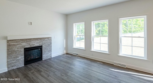 unfurnished living room with a fireplace and dark hardwood / wood-style flooring