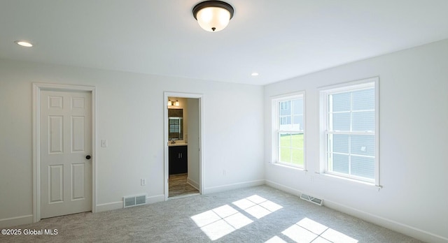 empty room with light colored carpet