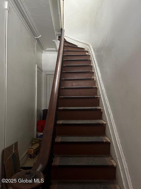 stairs featuring crown molding