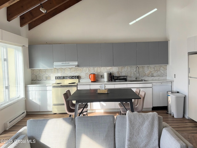 kitchen with white appliances, vaulted ceiling with beams, a baseboard heating unit, sink, and tasteful backsplash