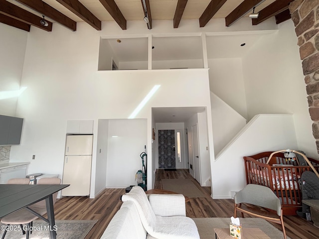 living room featuring dark wood-type flooring and beam ceiling