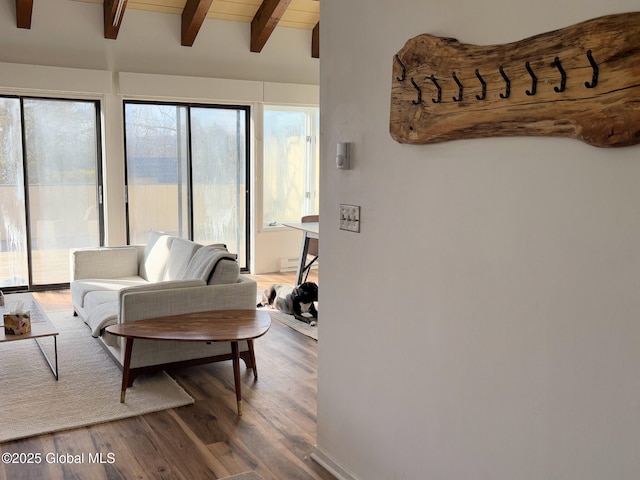 living room featuring hardwood / wood-style floors, wooden ceiling, and vaulted ceiling with beams