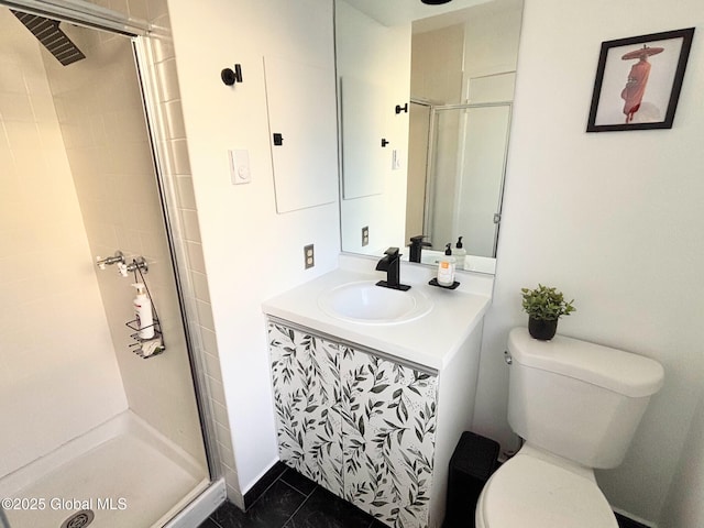 bathroom featuring toilet, a shower with door, tile patterned floors, and vanity