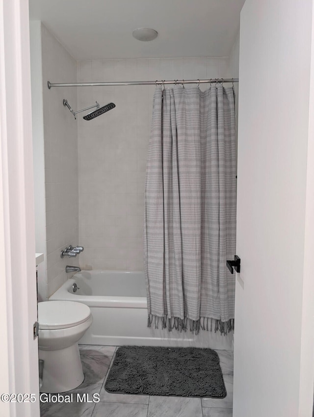 bathroom with toilet and shower / bath combo