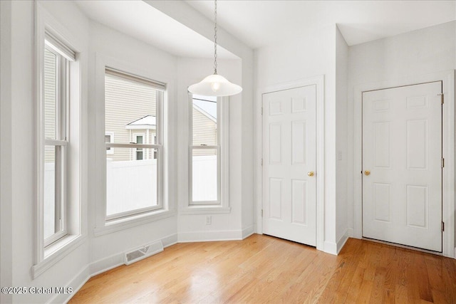 unfurnished dining area with light hardwood / wood-style flooring