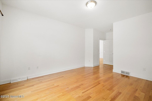 spare room with hardwood / wood-style floors