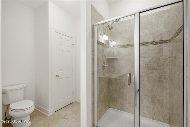 bathroom with a shower with door, tile patterned flooring, and toilet