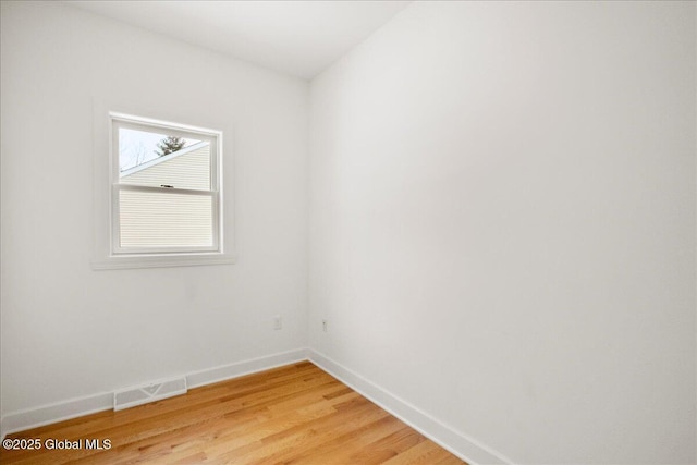 unfurnished room with hardwood / wood-style flooring