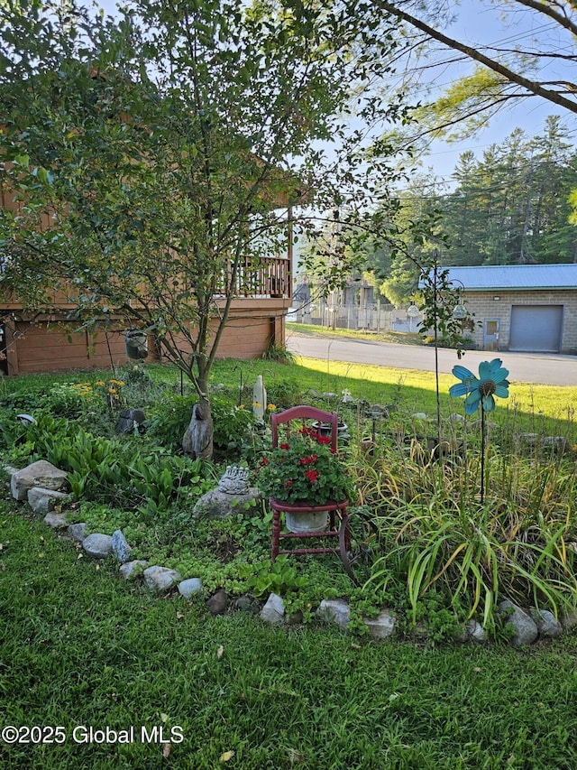 view of yard with a garage and a deck