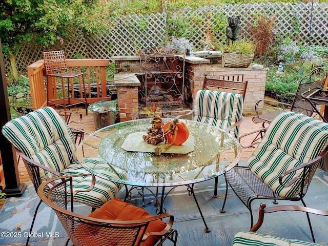 view of patio with an outdoor brick fireplace