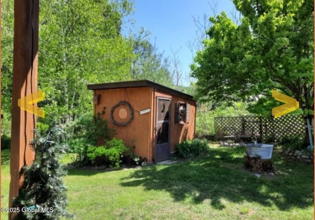 view of outbuilding featuring a lawn