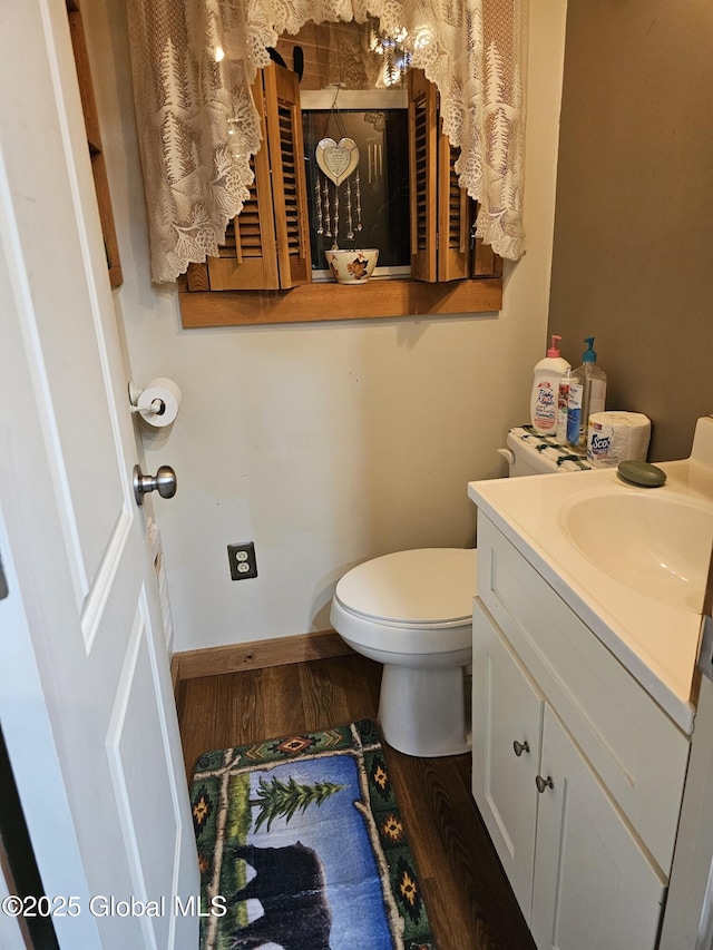 bathroom featuring toilet, hardwood / wood-style floors, and vanity