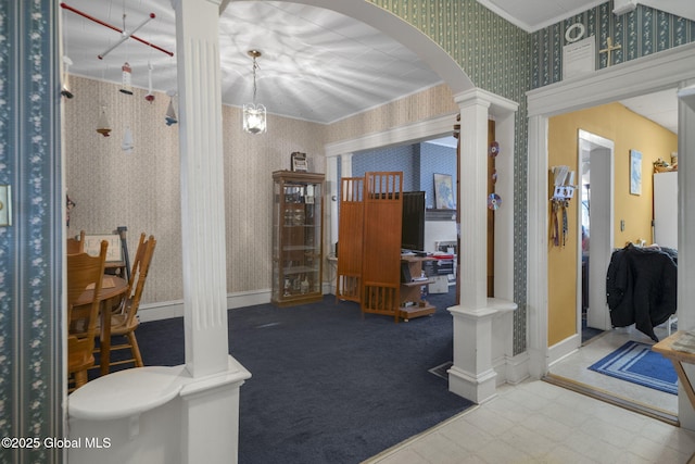 interior space with a chandelier, ornamental molding, and decorative columns