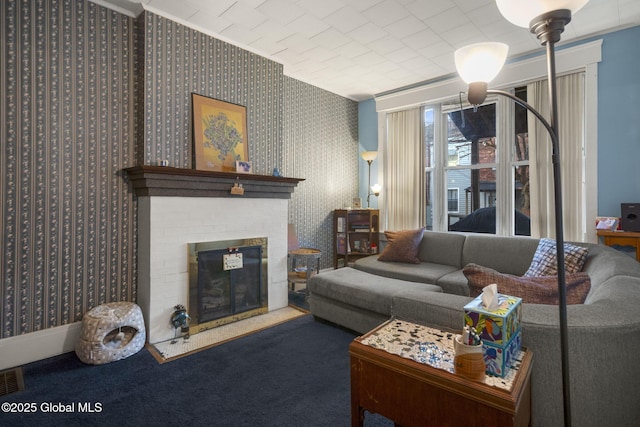 living room featuring a brick fireplace