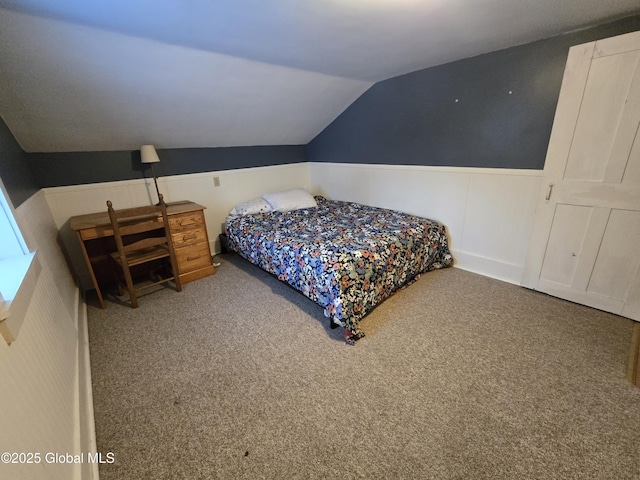 bedroom with carpet floors and vaulted ceiling