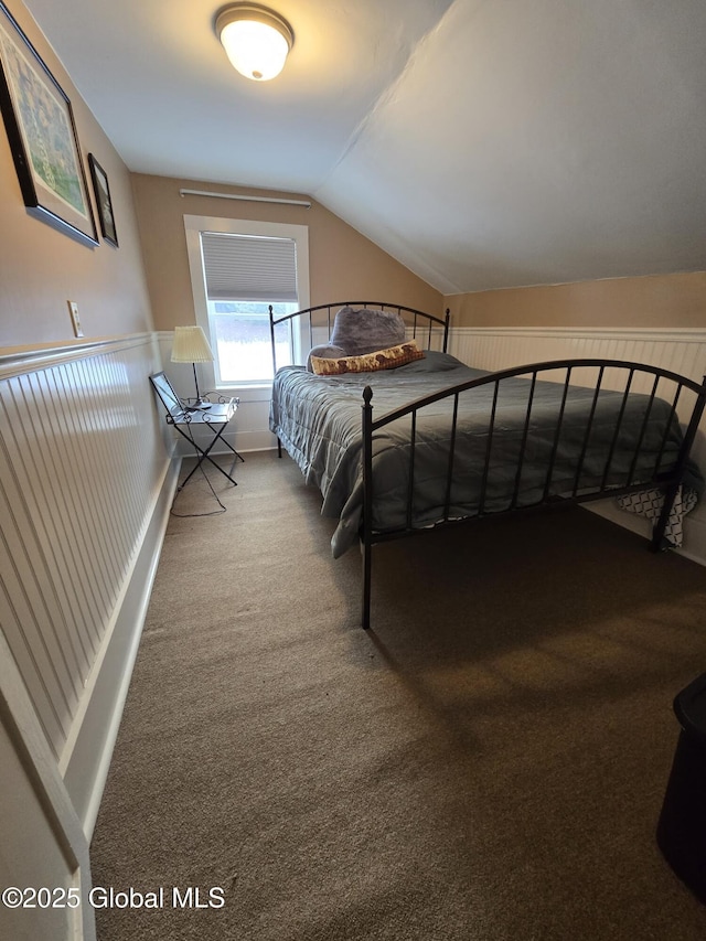 unfurnished bedroom with carpet flooring and lofted ceiling