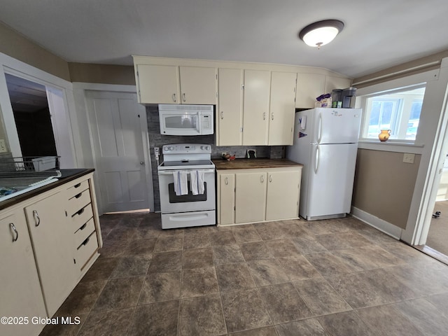 kitchen with white appliances and backsplash