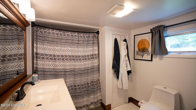 bathroom with vanity, toilet, and walk in shower