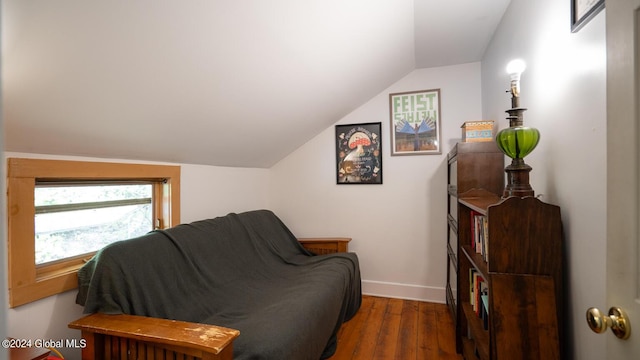 sitting room with dark wood-type flooring and lofted ceiling