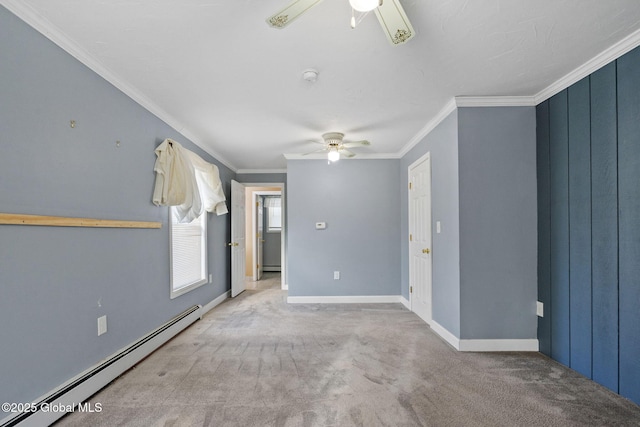 carpeted spare room with ceiling fan, a baseboard radiator, and ornamental molding