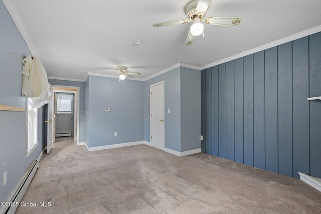 unfurnished room featuring baseboard heating, ceiling fan, crown molding, and light carpet