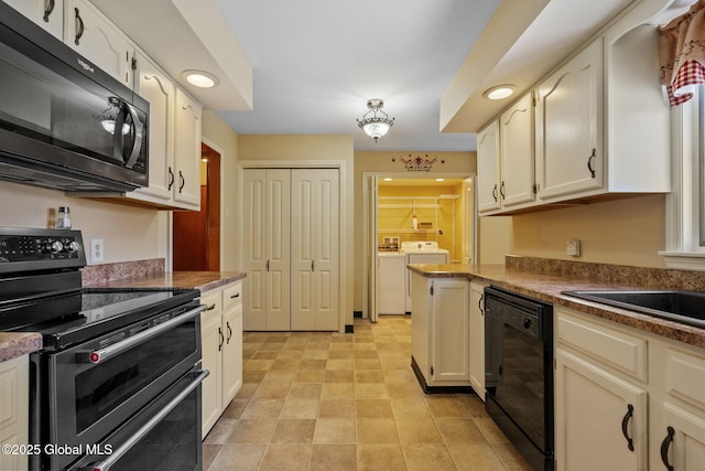 kitchen featuring range with two ovens, black dishwasher, and washing machine and clothes dryer