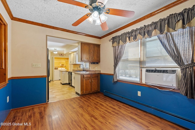 kitchen with a baseboard heating unit, crown molding, light hardwood / wood-style floors, and sink