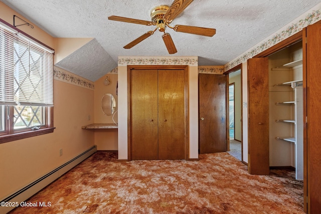 unfurnished bedroom with lofted ceiling, light carpet, a textured ceiling, a baseboard radiator, and two closets