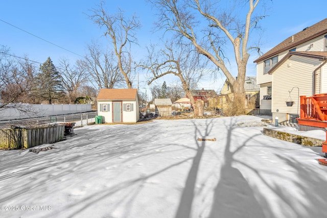 snowy yard with a storage unit