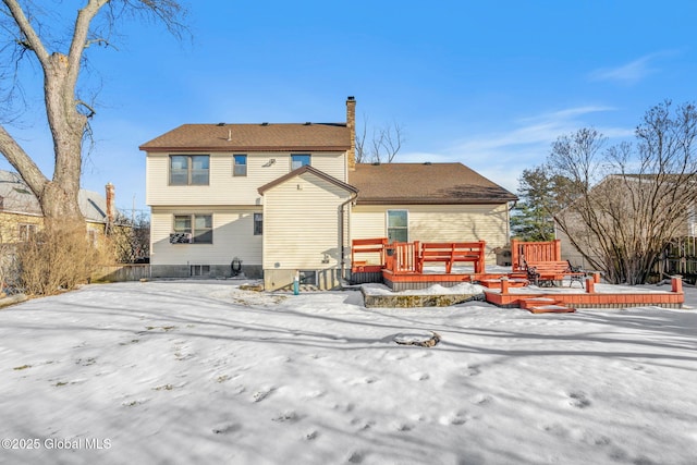 snow covered house featuring a wooden deck