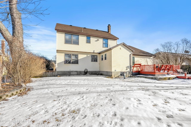 snow covered rear of property featuring a wooden deck