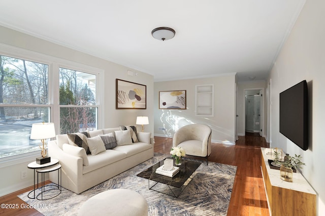 living room with dark hardwood / wood-style floors and ornamental molding