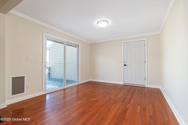 spare room with crown molding and wood-type flooring