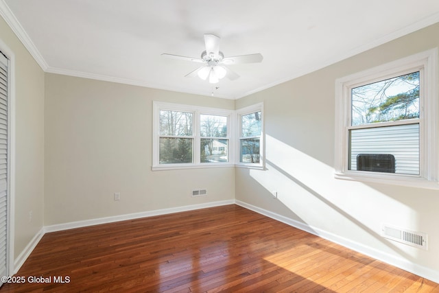 empty room featuring dark hardwood / wood-style flooring, ceiling fan, and ornamental molding