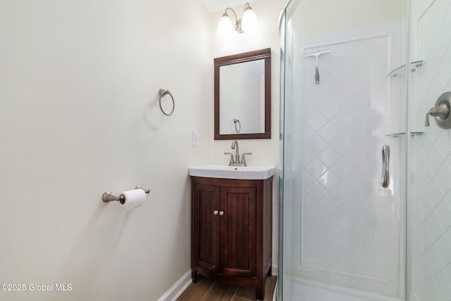 bathroom with hardwood / wood-style floors, vanity, and an enclosed shower