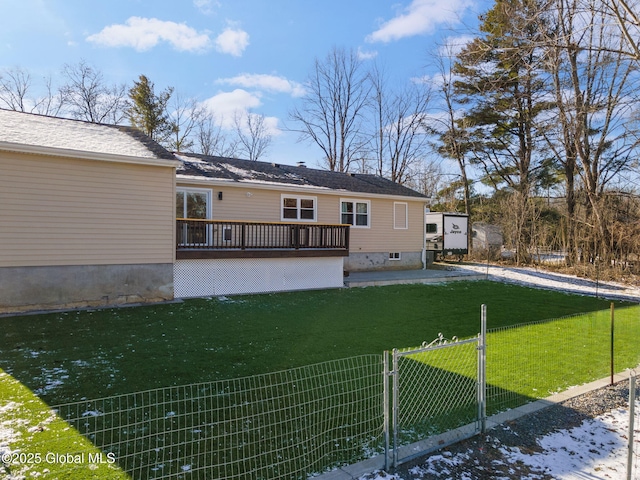 rear view of property with a lawn and a wooden deck