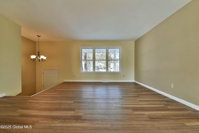 unfurnished room featuring a chandelier and wood-type flooring