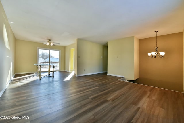 unfurnished room with dark wood-type flooring and ceiling fan with notable chandelier