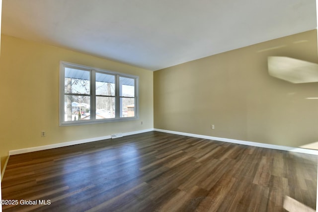 unfurnished room featuring dark hardwood / wood-style flooring